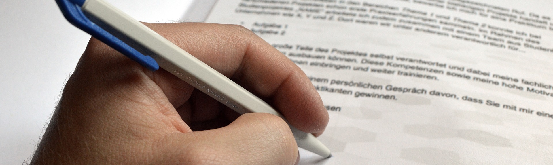 Close up of a hand writing on a piece of paper